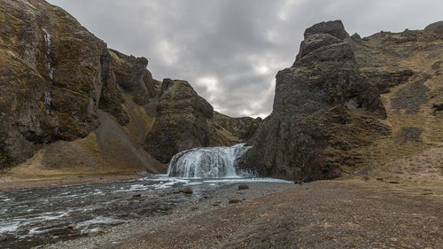 Full frame view of icy waterfall in rugged terrain
