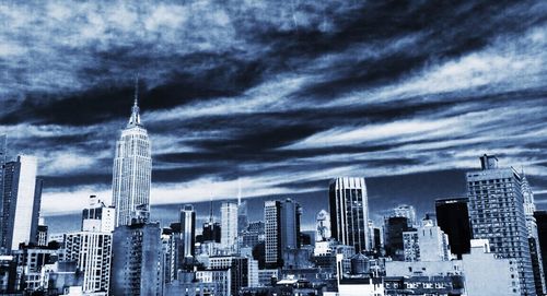 City skyline against cloudy sky