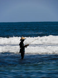 Man on sea against clear sky