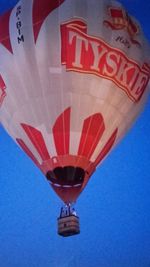 Low angle view of airplane flying against blue sky