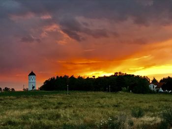 Scenic view of field against sky during sunset