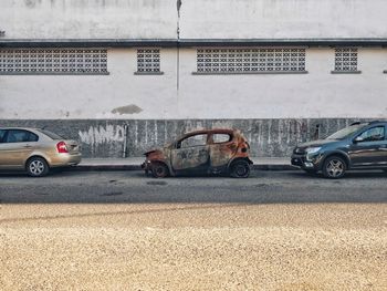 Cars parked on street by buildings in city