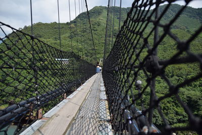 Panoramic shot of footbridge over chainlink fence