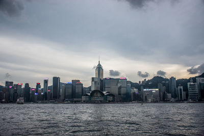 View of buildings in sea against cloudy sky