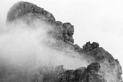 Low angle view of rock formation against sky