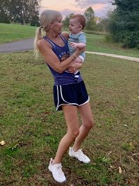 Full length of mother and girl on field