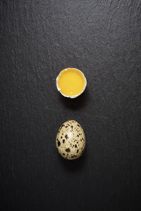 Quail eggs on a black table.