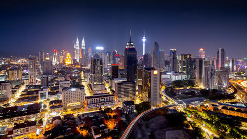 High angle view of city lit up at night