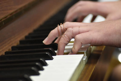 Cropped hands playing piano