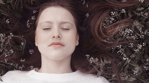 Close-up portrait of a young woman with eyes closed