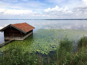 Built structure in lake against sky