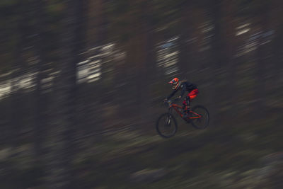 Blurred motion of man riding motorcycle