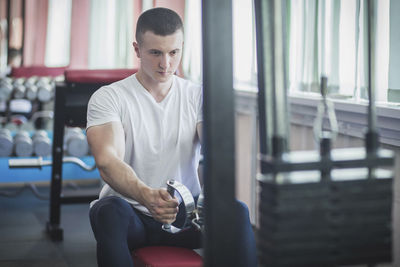 Young man exercising in gym
