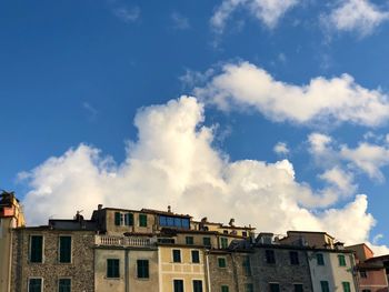 Low angle view of buildings in town against sky, tellaro 