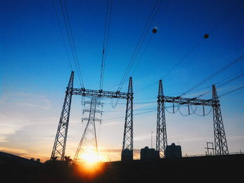 Low angle view of electricity pylon against sky
