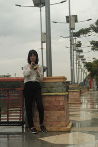 Full length of young man standing against sky