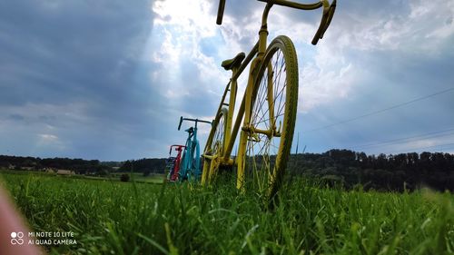 Low angle view of traditional windmill on field against sky