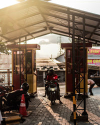 Rear view of people sitting on street in city