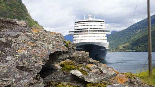 Ms koningsdam on river against cloudy sky