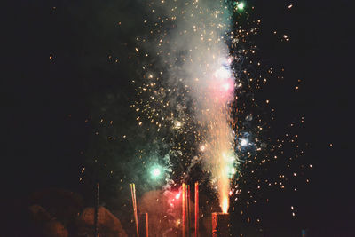 Low angle view of firework display at night