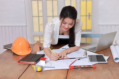 Young woman using laptop on table