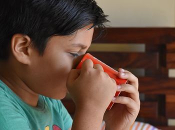 Close-up portrait of boy holding mug