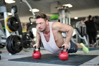 Midsection of man with arms raised