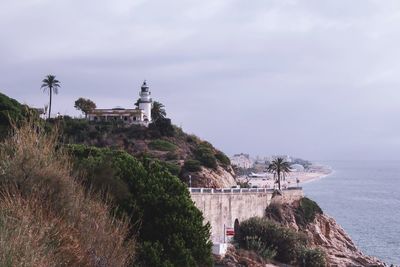 View of building by sea against sky