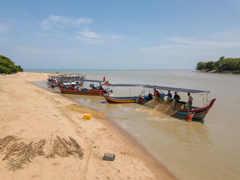 View of boats in sea against sky