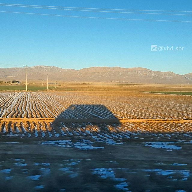 clear sky, landscape, tranquil scene, blue, tranquility, field, mountain, nature, sky, scenics, rural scene, road, transportation, beauty in nature, copy space, agriculture, non-urban scene, the way forward, outdoors, remote