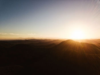 Scenic view of silhouette mountains against sky during sunset