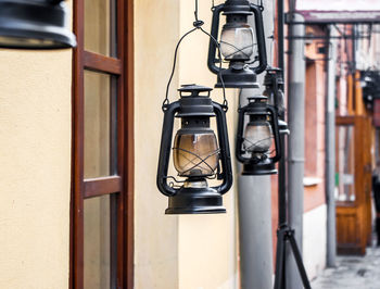 Close-up of electric lamp against door