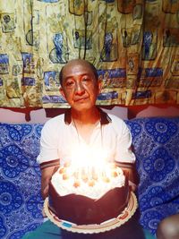 Portrait of man sitting at home