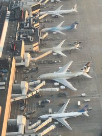 High angle view of airplane flying in city