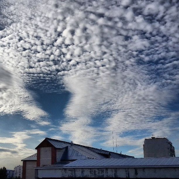 architecture, built structure, building exterior, sky, cloud - sky, low angle view, cloudy, cloud, house, weather, residential structure, roof, building, high section, residential building, outdoors, overcast, city, day, no people