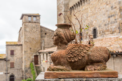 Statue against historic building