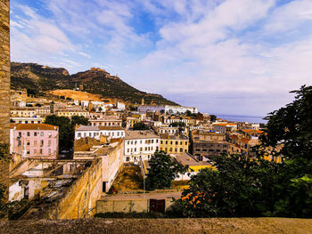 Buildings in town against sky