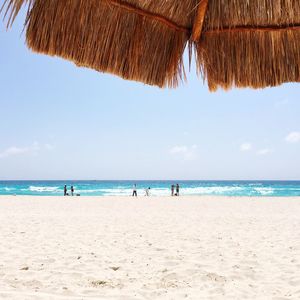 Scenic view of beach against blue sky