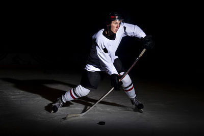 Full length of man playing ice hockey