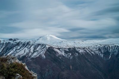 Scenic view of snowcapped mountains against sky