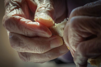 Close-up of man holding bread