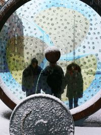 Rear view of people sitting in rain