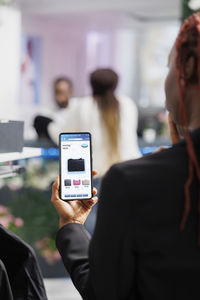 Midsection of businessman using mobile phone