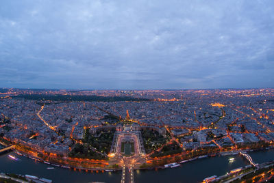 Aerial view of illuminated city against sky at night