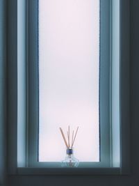 Close-up of glass window on wall at home