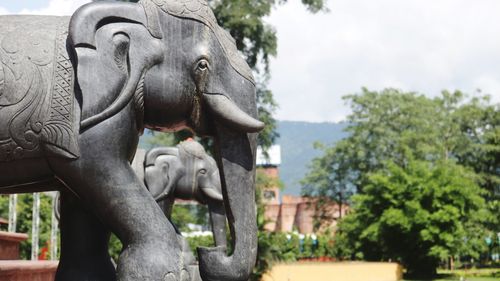 Close-up of elephant statue against sky