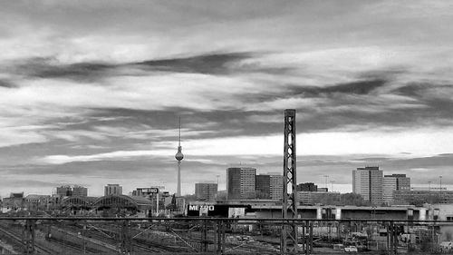 Fernsehturm and buildings in city against sky