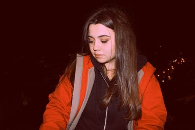 Close-up of young woman at night
