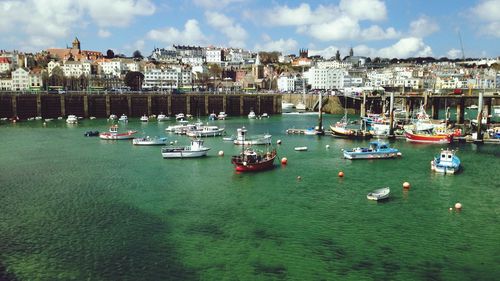 View of boats moored in sea against buildings