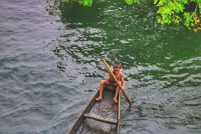 High angle view of shirtless man in water